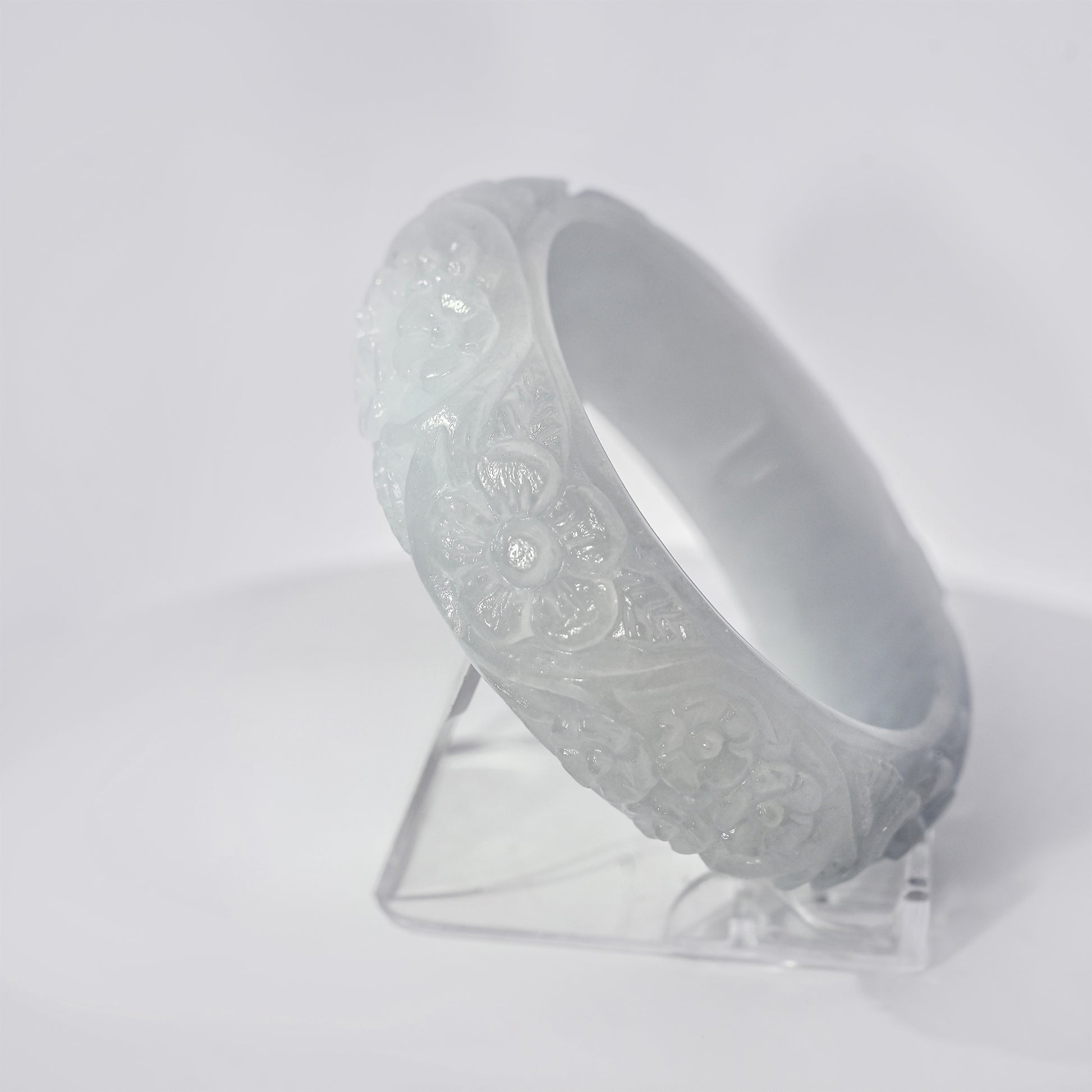 61mm White Flower Carved Jade Bangle, upright edge view on display stand, authentic Type A Burma jadeite, Brother Ryan Shop