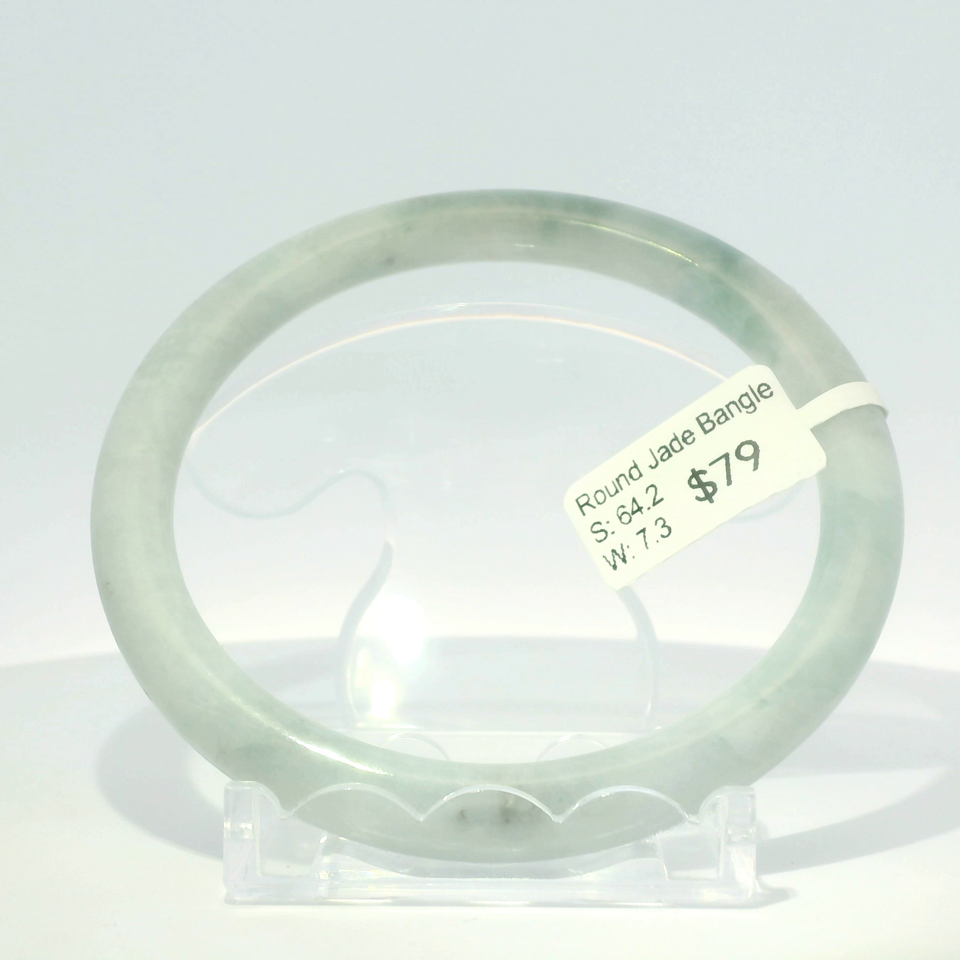 Natural Burmese jadeite bangle, white base with apple green tones, 64.2mm inner diameter