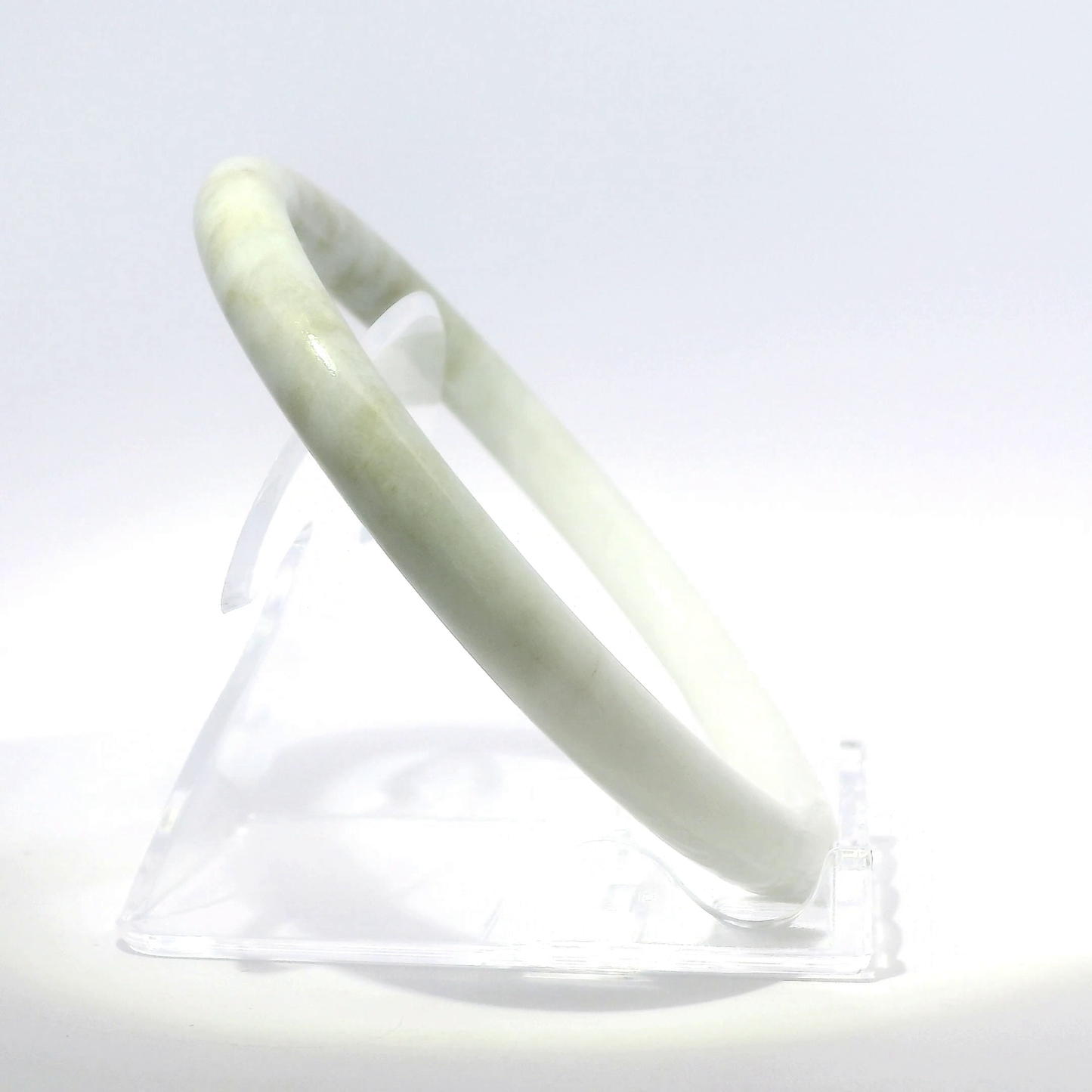 Natural Burmese Jadeite Bangle 61mm white mountain jade angled side view on stand - SL720
