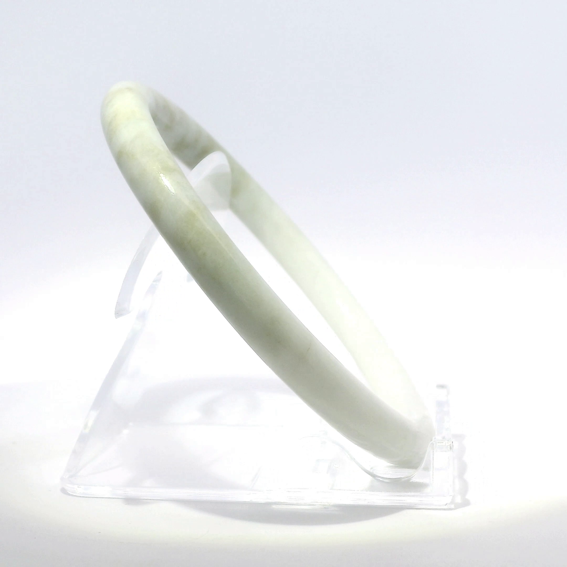Natural Burmese Jadeite Bangle 61mm white mountain jade angled side view on stand - SL720