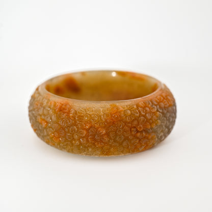 Floral-engraved raw honey Burmese jadeite bangle cuff with bright honey patterns