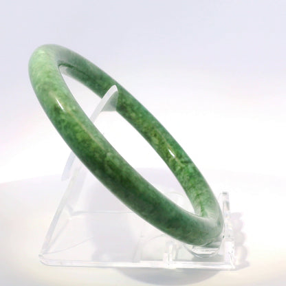 63mm Candy Apple Green Round Jade Bangle, upright edge view on display stand, authentic Type A Burma jadeite, Brother Ryan Shop