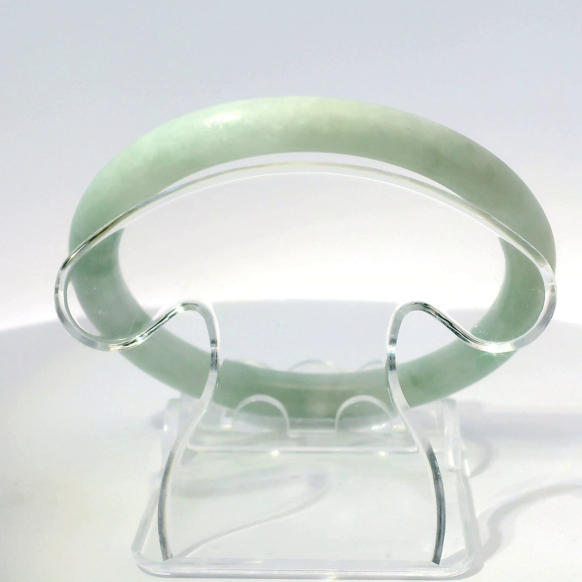 56mm Golden Mountain Round Jade Bangle, top-down view on display stand, authentic Type A Burma jadeite, Brother Ryan Shop