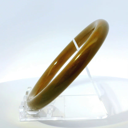63mm Raw Honey Round jade bangle, angled side view on display stand, authentic Type A Burma jadeite, Brother Ryan Shop