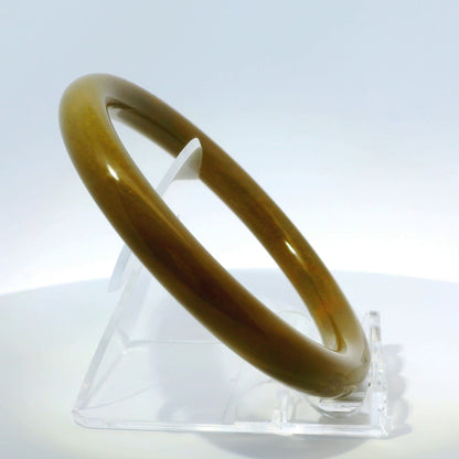 63mm Raw Honey Round jade bangle, upright edge view on display stand, authentic Type A Burma jadeite, Brother Ryan Shop