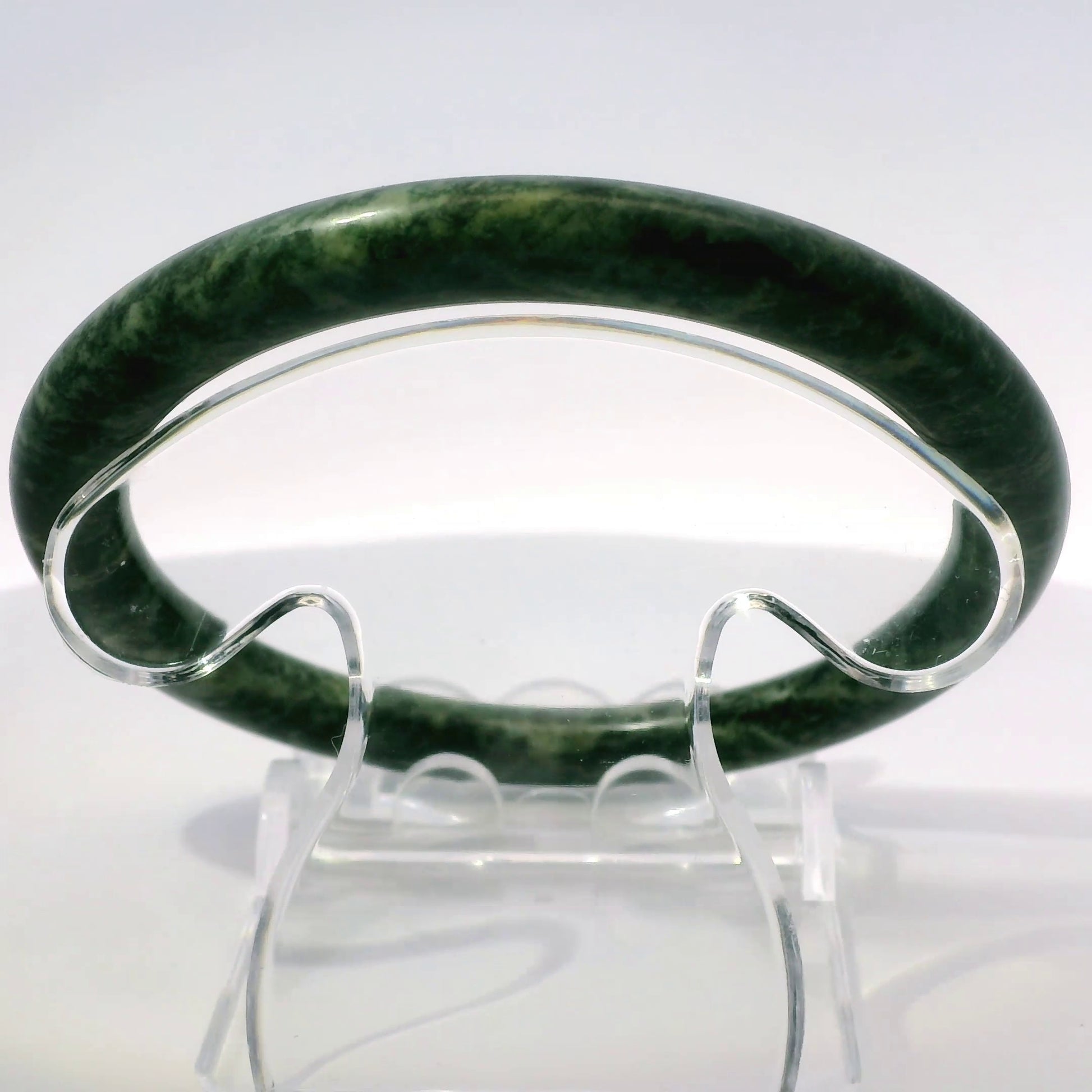 60mm Fiery Forest Round Jade Bangle, upright edge view on display stand, authentic Type A Burma jadeite, Brother Ryan Shop