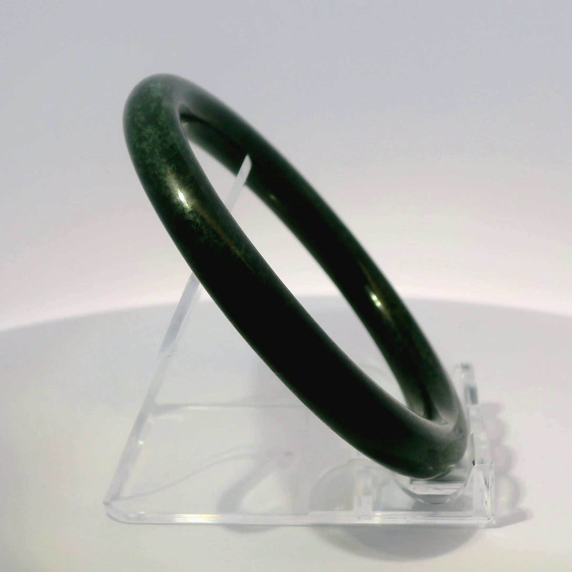 59mm Black Round Cut Jade Bangle, upright edge view on display stand, authentic Type A Burma jadeite, Brother Ryan Shop