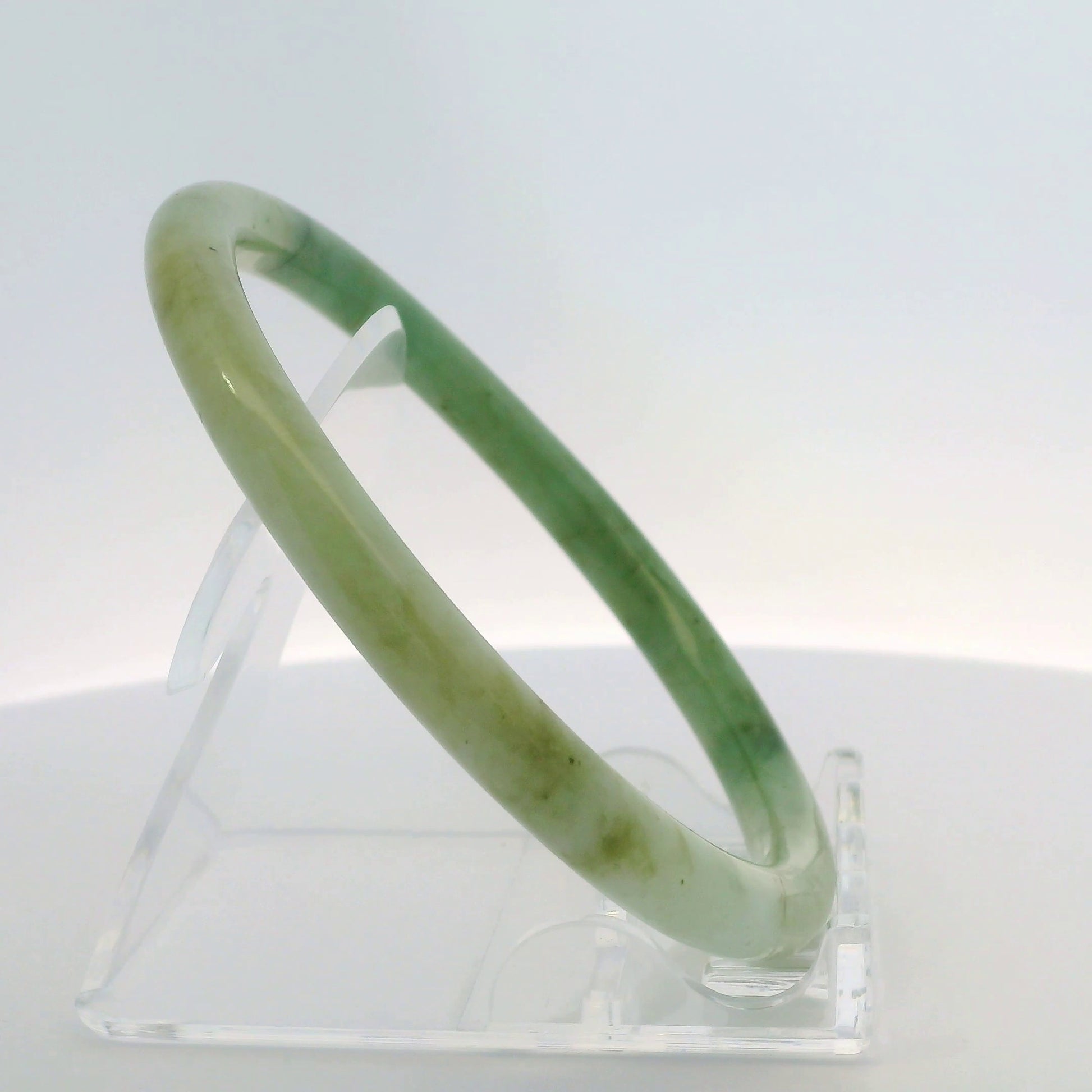 61mm Banana Leaf Round Jade Bangle, angled side view on display stand, authentic Type A Burma jadeite, Brother Ryan Shop